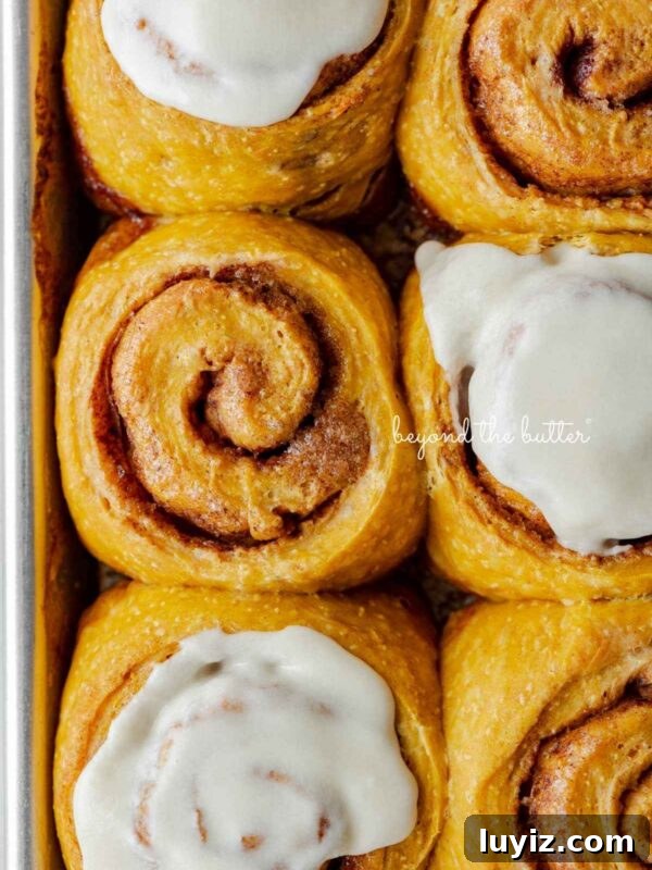 Pumpkin Whoopie Pies Recipe: Soft Spiced Sandwich Cookies 20 Six pumpkin cinnamon rolls with three topped with maple frosting placed on a small baking sheet.