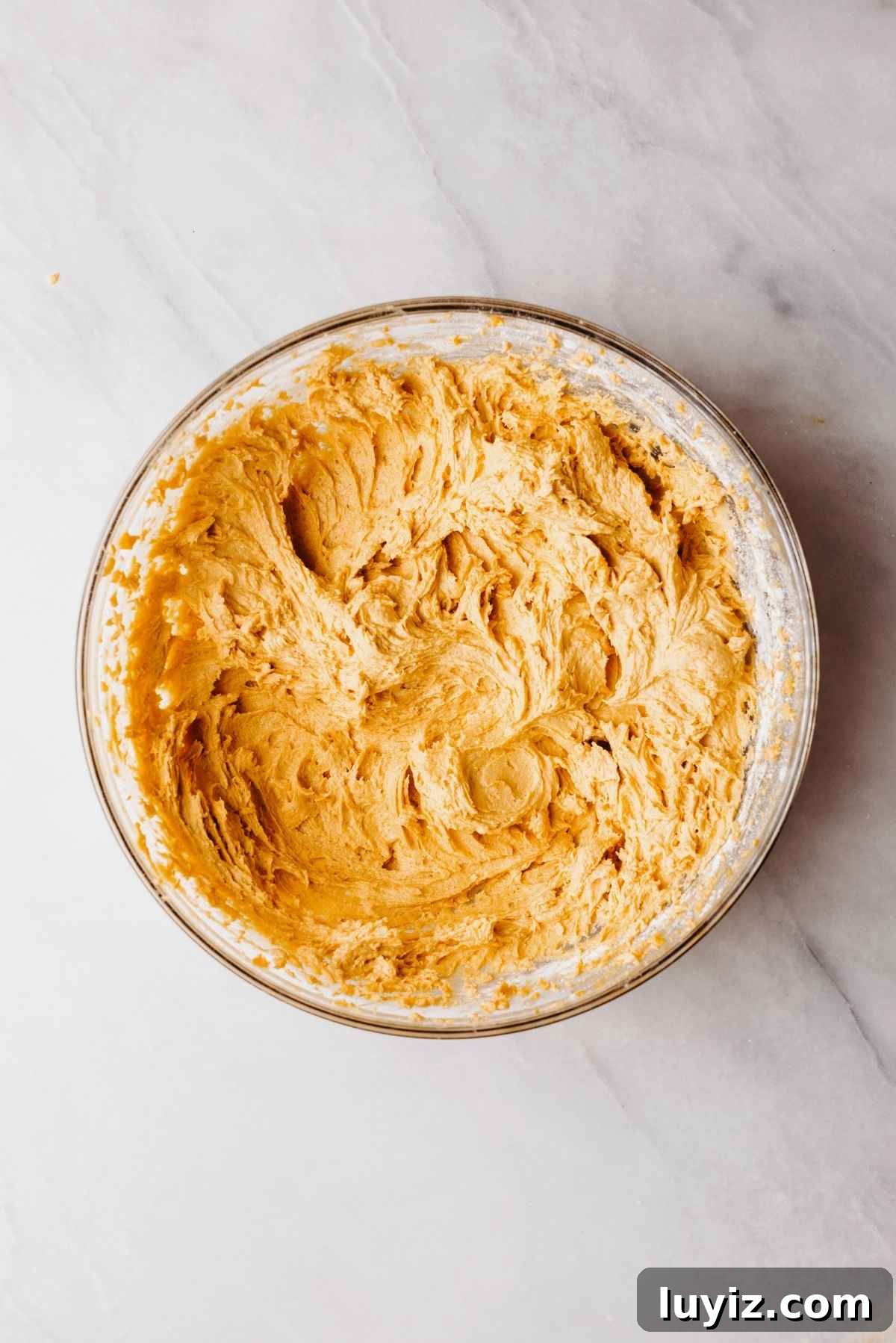 Pumpkin Whoopie Pies Recipe: Soft Spiced Sandwich Cookies 10 Pumpkin whoopie pie batter in a large glass mixing bowl on a light grey marbled background.