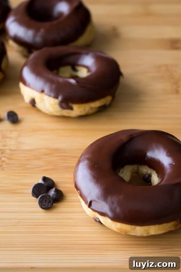 Chocolate Chip Doughnuts. Cake doughnuts baked in a doughnut pan, filled with chocolate chips & dipped in chocolate glaze - Say hello to your new favorite breakfast!