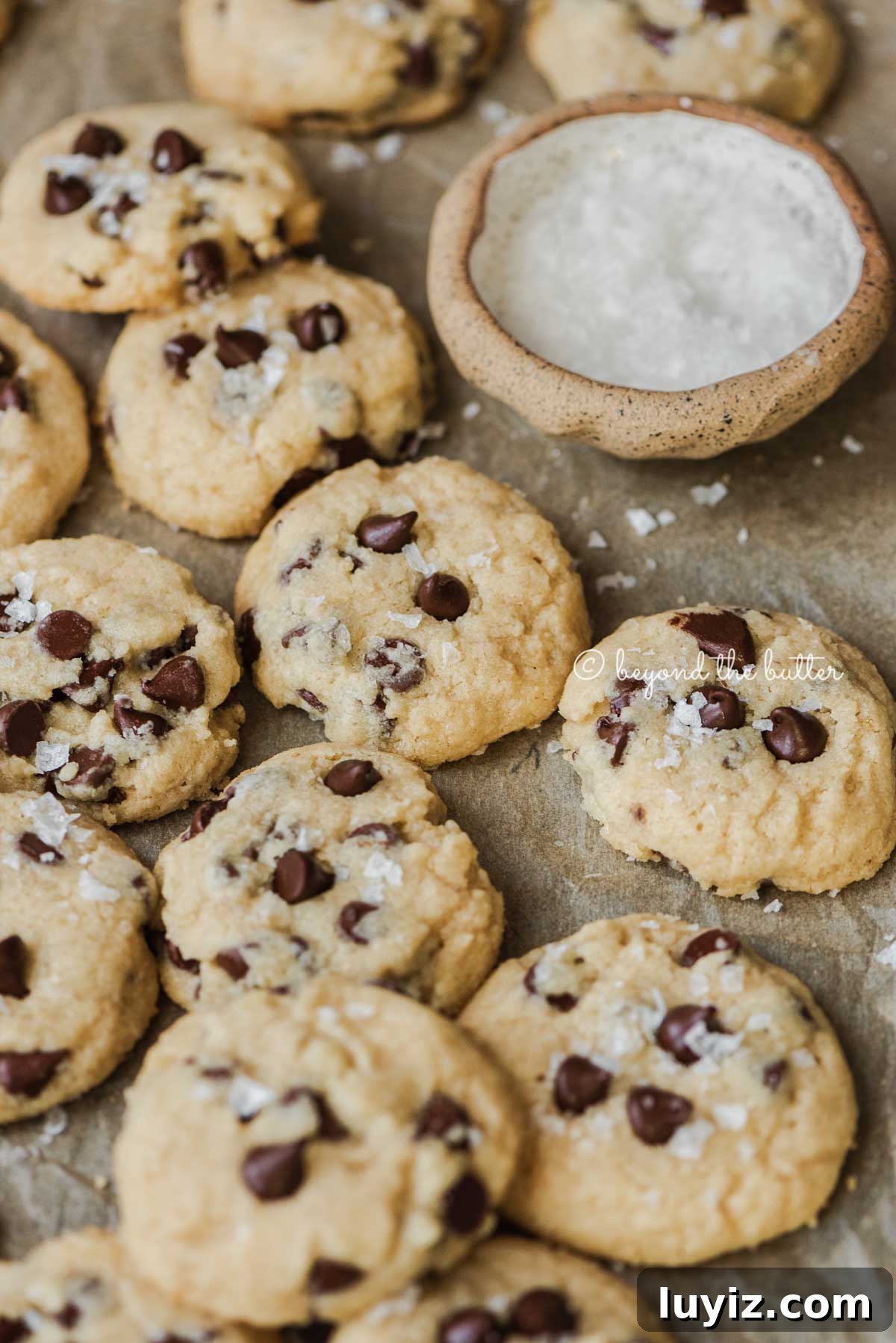 Classic Chocolate Chip Shortbread Cookies Recipe 6 Freshly baked salted chocolate chip shortbread cookies cooling on parchment paper lined cookie sheet | All Images © Beyond the Butter®