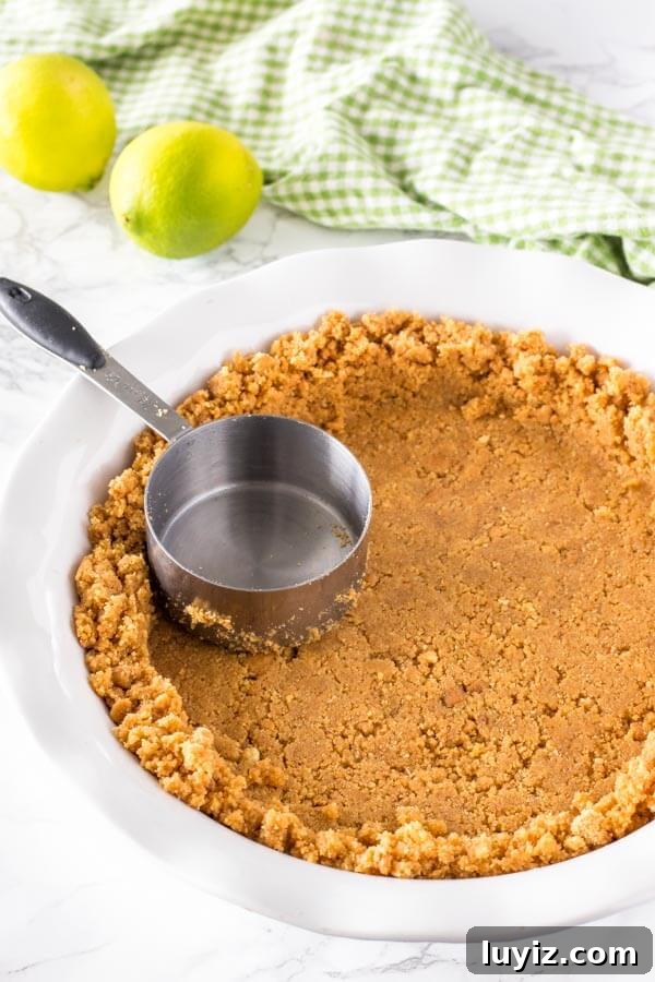 No-Bake Key Lime Pie Recipe (Quick, Creamy & Zesty) 4 Making the graham cracker crust for no bake key lime pie by pressing the graham crumb mixture into the bottom and up the sides of the pie plate.