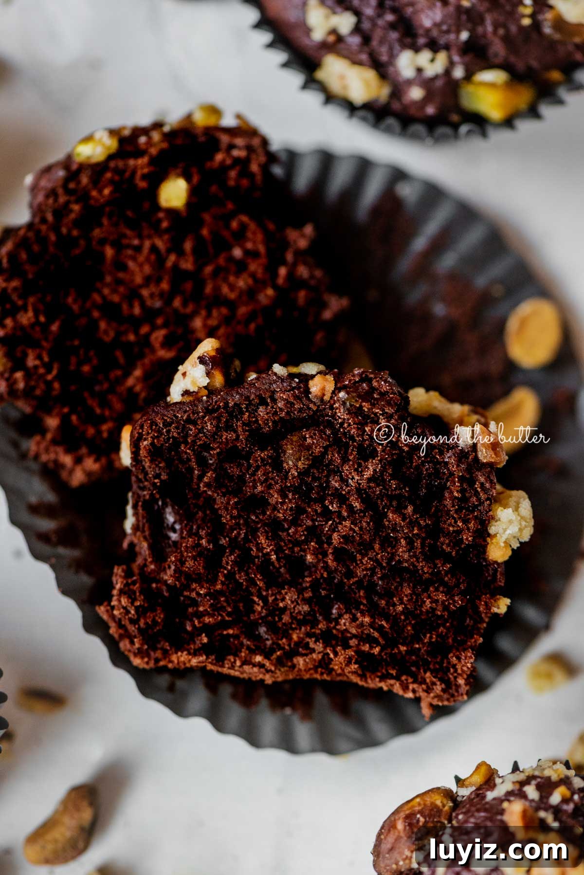 Dark Chocolate Pistachio Cream Cheese Muffins Recipe 5 Dark chocolate pistachio cream cheese muffins with center muffin unwrapped and cut in half | All Images © Beyond the Butter™