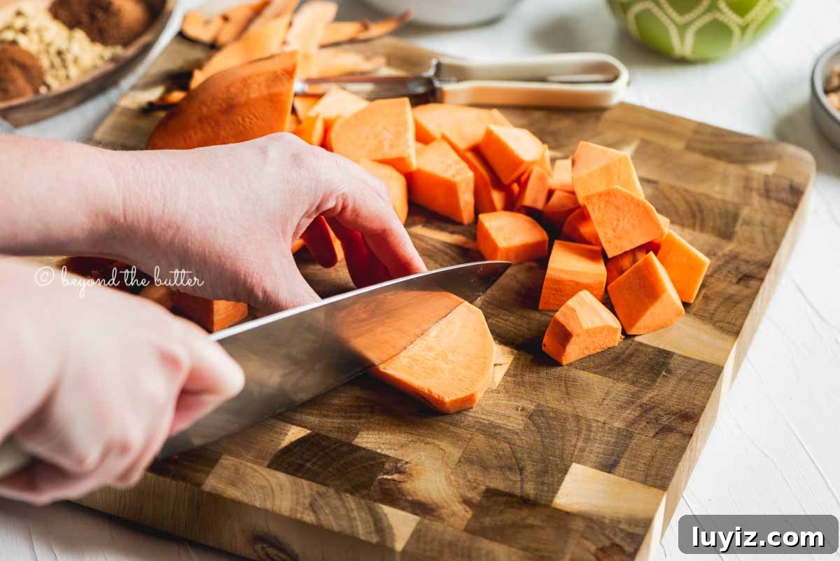 Brown Sugar Sweet Potato Pie Recipe — Classic Southern Dessert 7 Cutting chunks of sweet potato