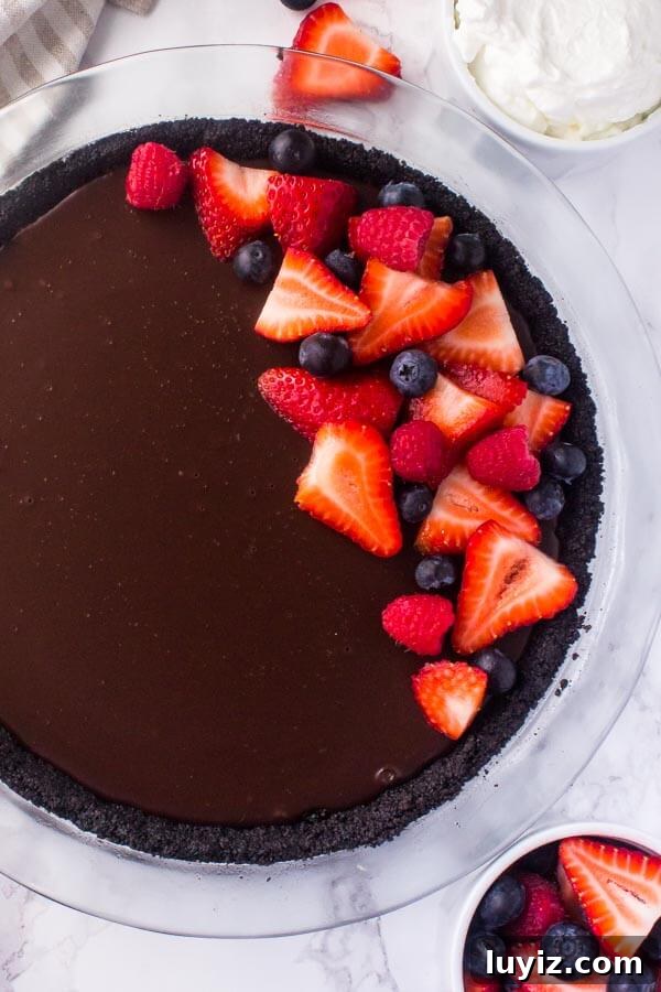 No bake chocolate pie with a graham cracker crust, and thick fudgy chocolate ganache.