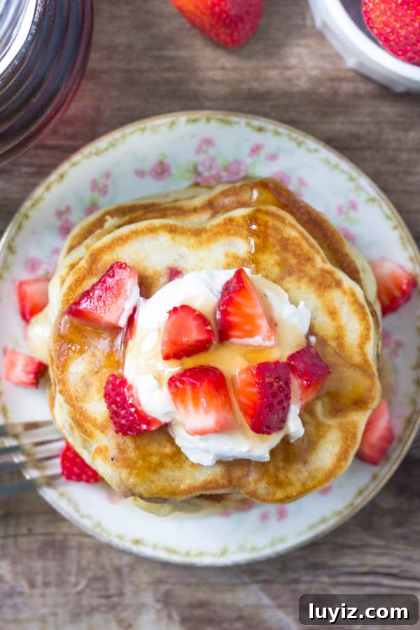 Fluffy Strawberry Pancakes with Sweet Maple Glaze 3 Strawberry Pancake Recipe - these pancakes are fluffy, tender, and filled with strawberries in every bite.