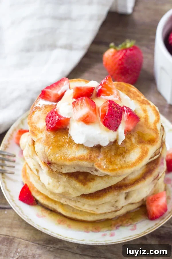 Fluffy Strawberry Pancakes with Sweet Maple Glaze 5 Strawberry pancakes are extra fluffy and filled with berries. Top them with maple syrup of strawberry syrup for the perfect breakfast.
