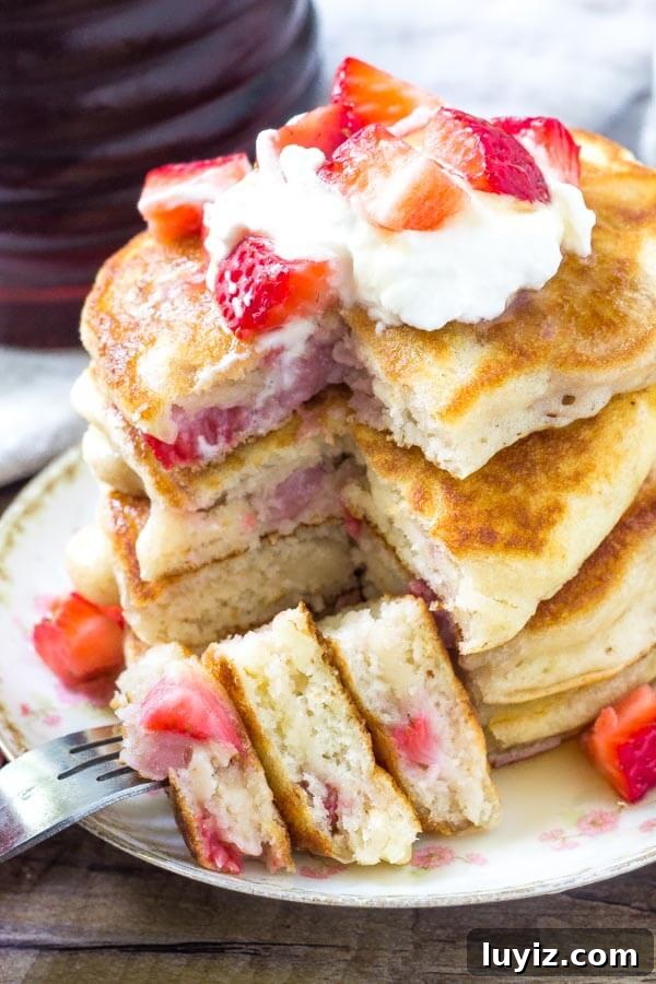 Fluffy Strawberry Pancakes with Sweet Maple Glaze 6 Fluffy strawberry pancakes are perfectly stackable, filled with pieces of strawberries, and perfect for breakfast or dessert.