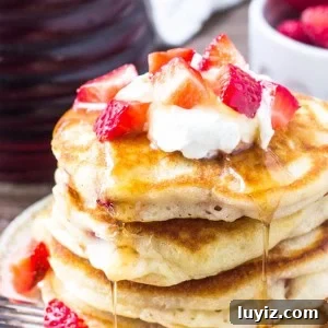 These strawberry pancakes are extra fluffy with golden edges and filled with juicy berries in every bite. They're a delicious, easy, breakfast recipe that comes together in no time.