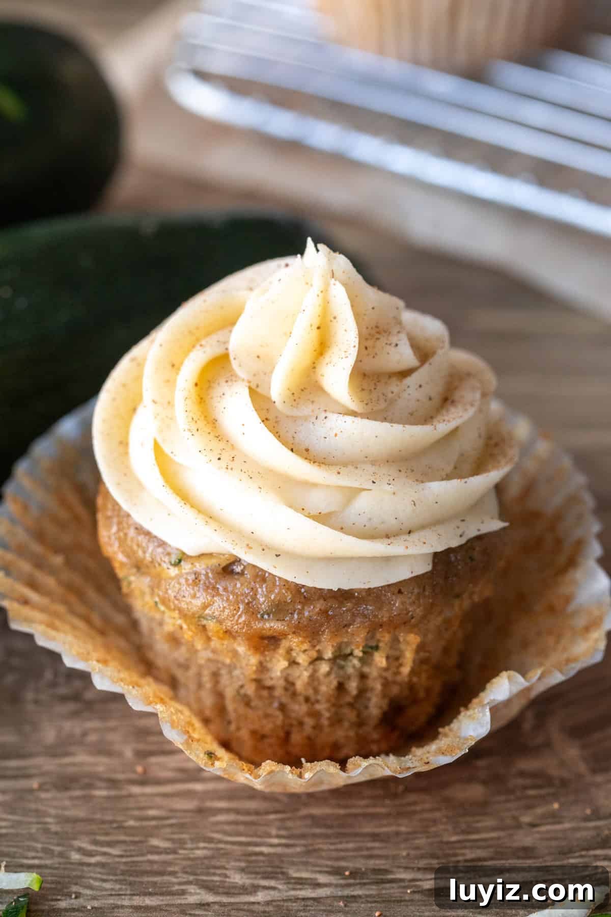 Zucchini Cupcakes with Cream Cheese Frosting Recipe 2 Zucchini cupcake with cinnamon cream cheese frosting with cupcake paper peeled back
