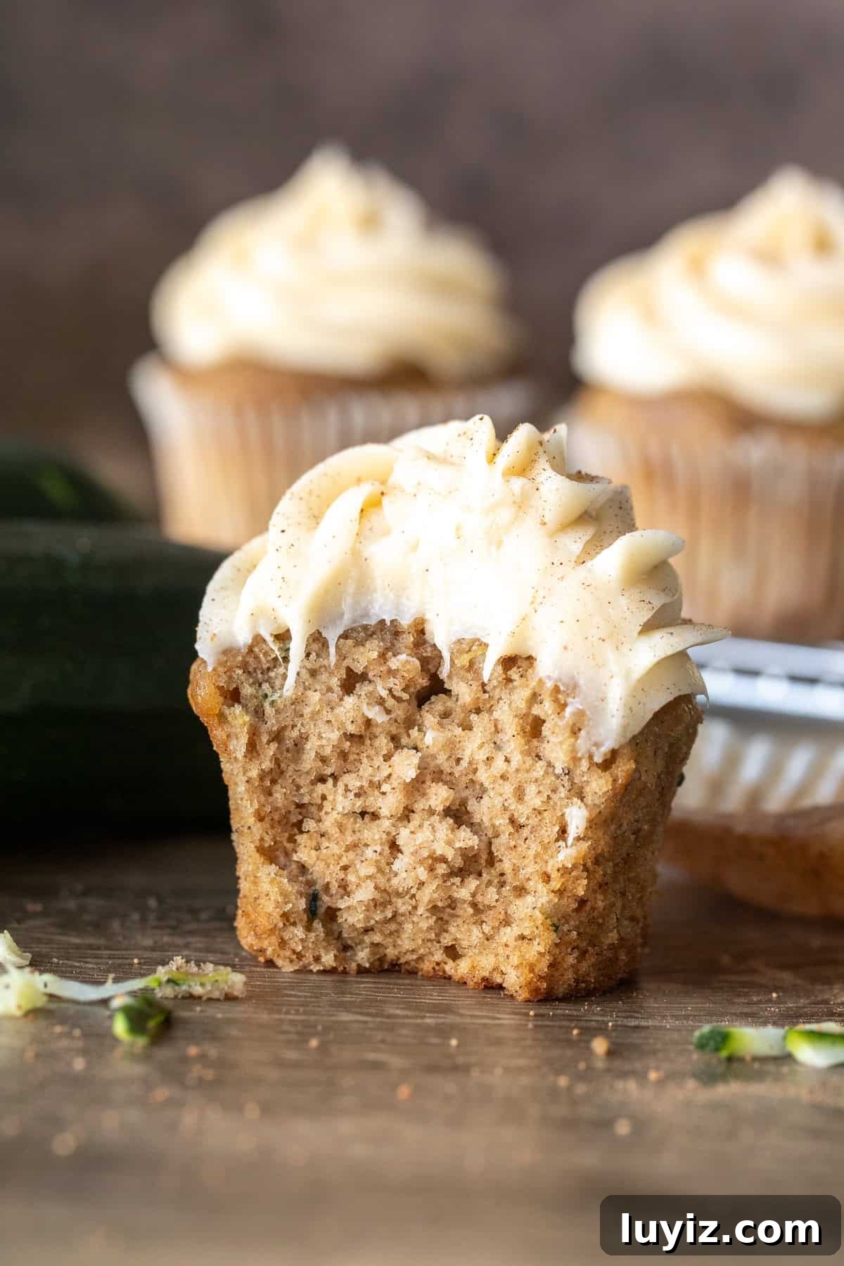Zucchini Cupcakes with Cream Cheese Frosting Recipe 8 Zucchini cupcake with cream cheese frosting with bite taken out
