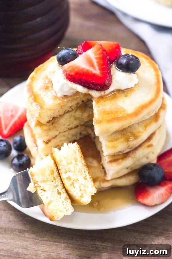 Fluffy Cream Cheese Pancakes with Vanilla and Lemon Zest 4 Extra fluffy cream cheese pancakes topped with fresh fruit & whipped cream make for the perfect breakfast.