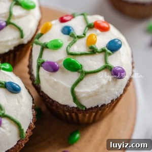 Gingerbread Cupcakes Recipe for a Small Batch (6 Muffins) 7 Small batch of gingerbread cupcakes on an upside down pie plate on a white background with scattered chocolate covered sunflower seeds.