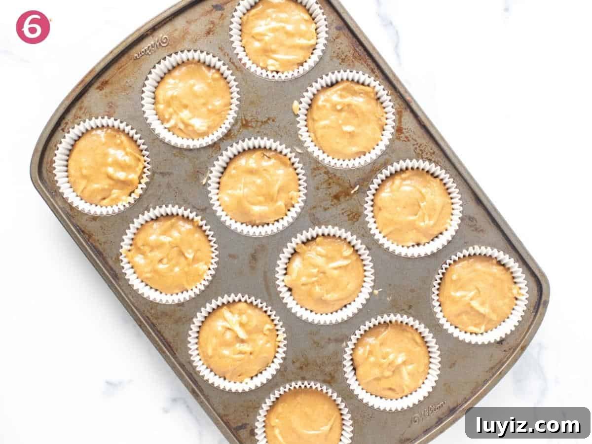Apple Cupcakes with Cinnamon Cream Cheese Frosting 5 Apple cupcake batter spooned into lined muffin tin