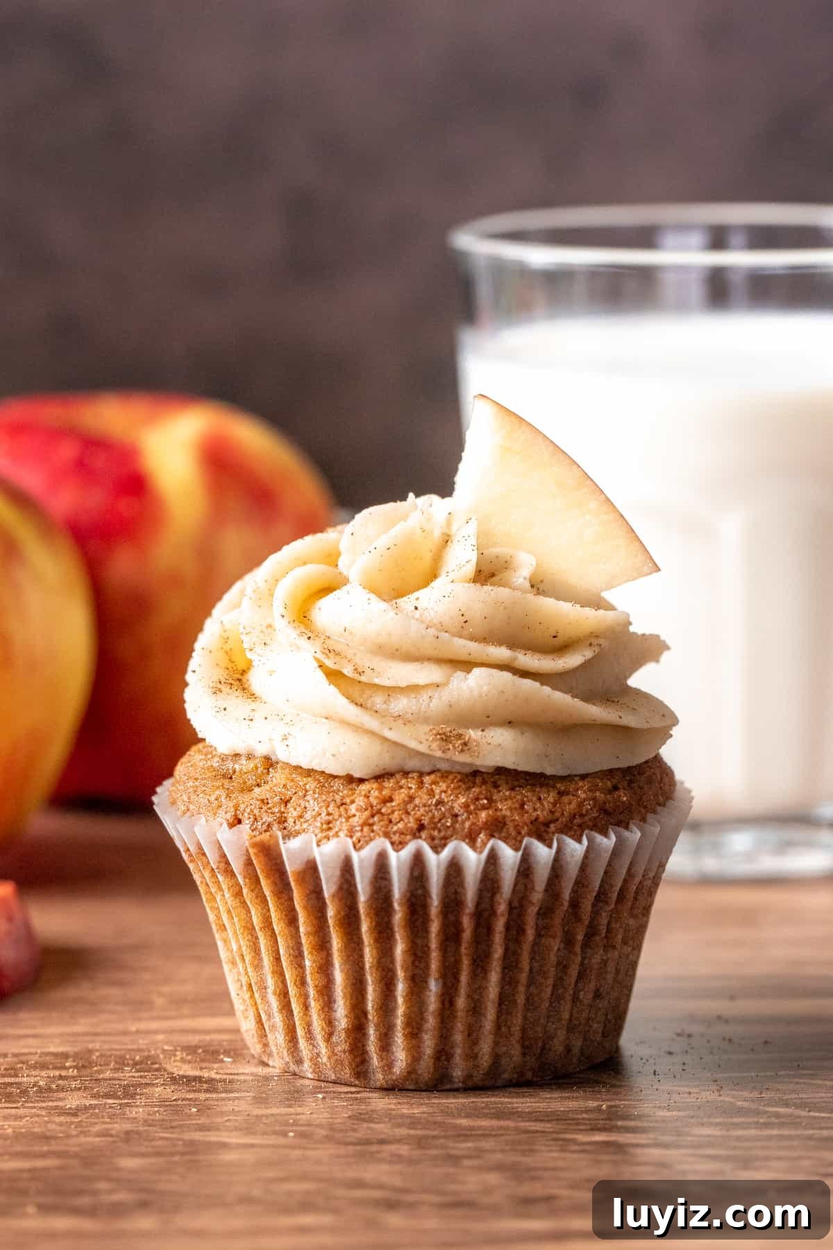 Apple Cupcakes with Cinnamon Cream Cheese Frosting 6 Apple cupcake with glass of milk and 2 apples