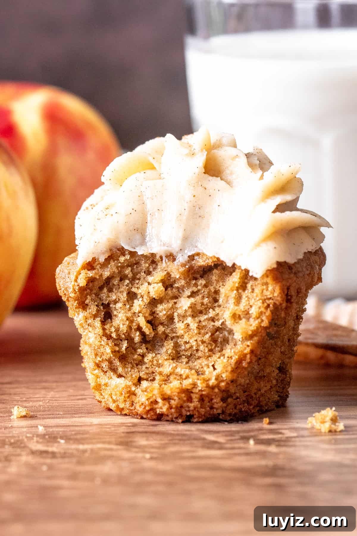 Apple Cupcakes with Cinnamon Cream Cheese Frosting 7 Apple spice cupcake with a bite taken out