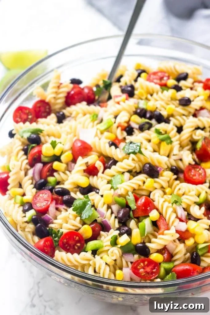 Southwest-Style Pasta Salad with Corn, Black Beans & Avocado 2 Southwest pasta salad: pasta with corn, black beans, vegetables and cilantro dressed in chili lime vinaigrette