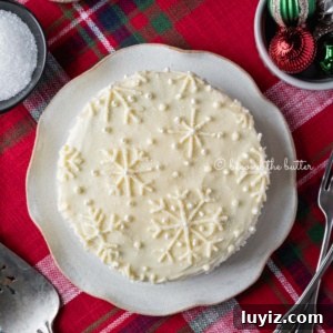 Simple Single-Layer Red Velvet Cake Recipe for Perfect Results 13 Red velvet cake with cream cheese frosting on a scalloped edge dessert plate with red plaid background.