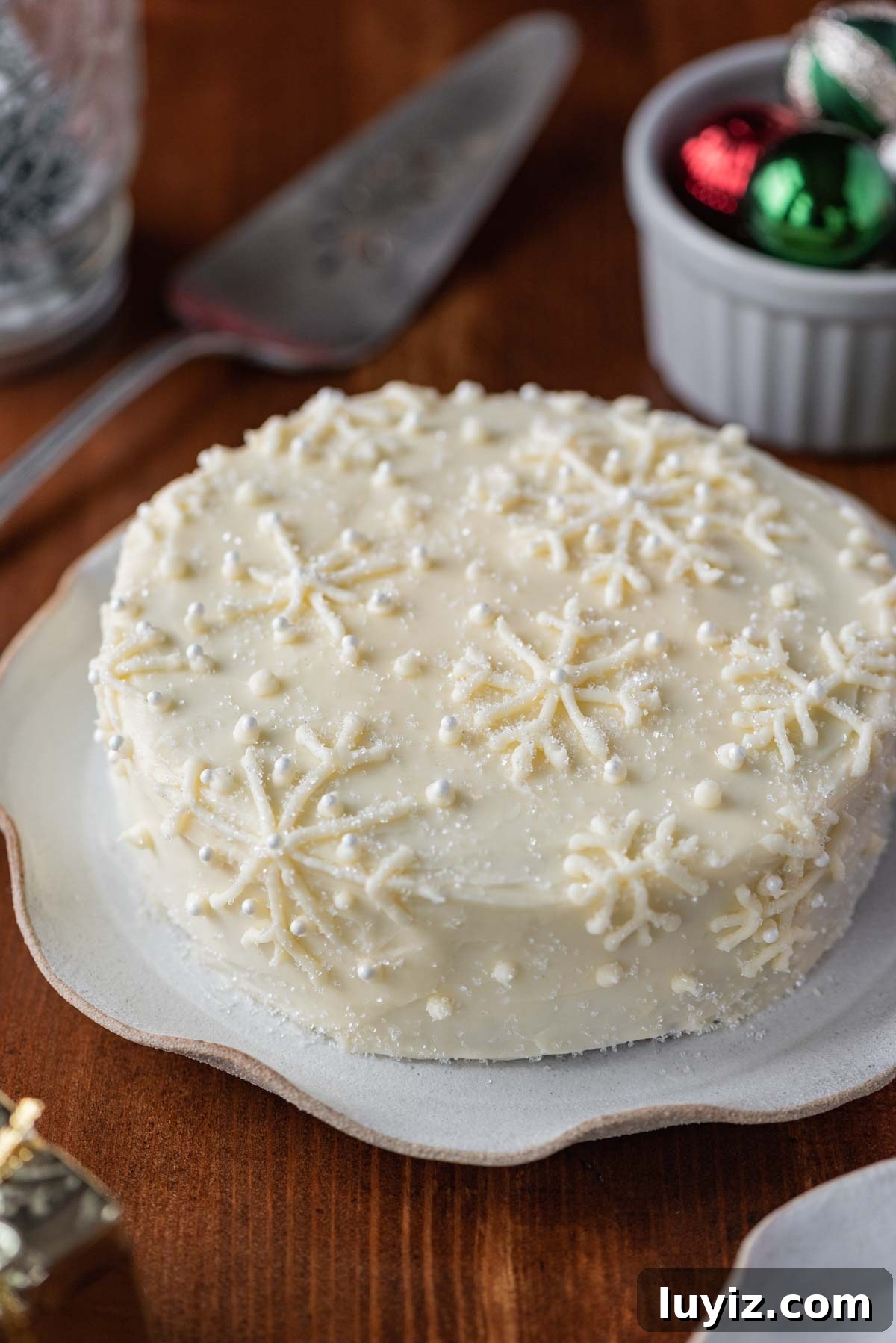 Simple Single-Layer Red Velvet Cake Recipe for Perfect Results 6 Red velvet cake with cream cheese frosting on a scalloped edge dessert plate with dark wood background | All Images © Beyond the Butter®