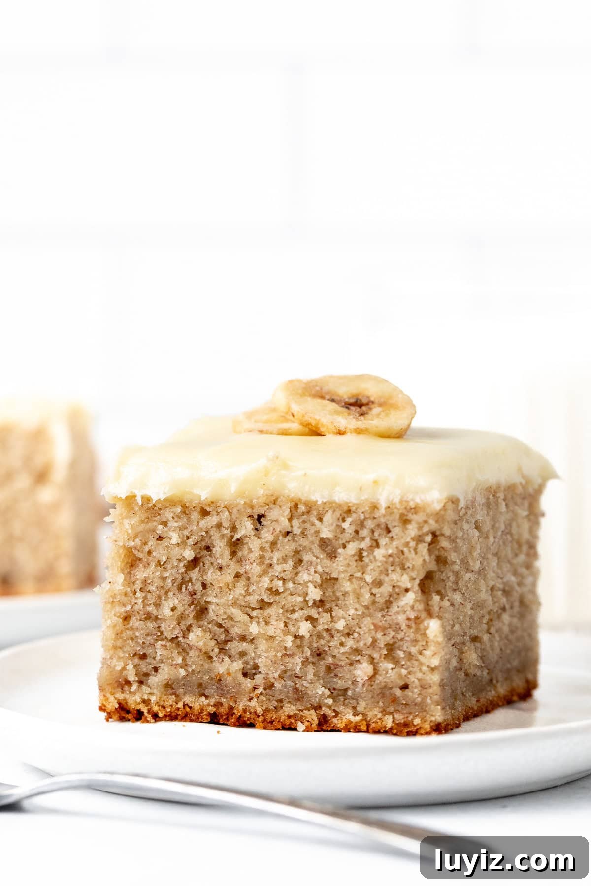 Moist Banana Cake Recipe: Simple Step-by-Step Guide 2 Slice of banana cake with cream cheese frosting