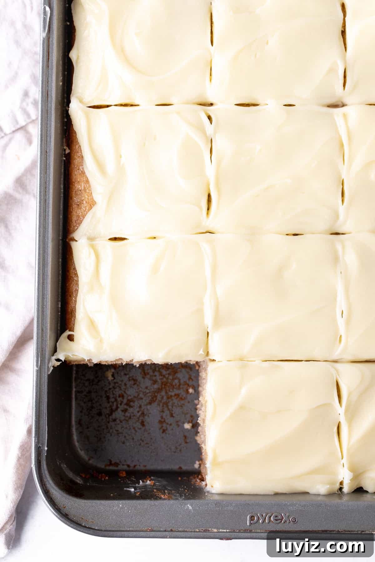 Moist Banana Cake Recipe: Simple Step-by-Step Guide 7 9x13 inch pan of banana cake with cream cheese frosting cut into squares