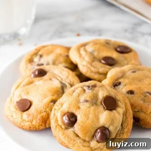 Chewy Chocolate Chip Pudding Cookies Recipe 6 A plate of chewy chocolate chip pudding cookies with a glass of milk.