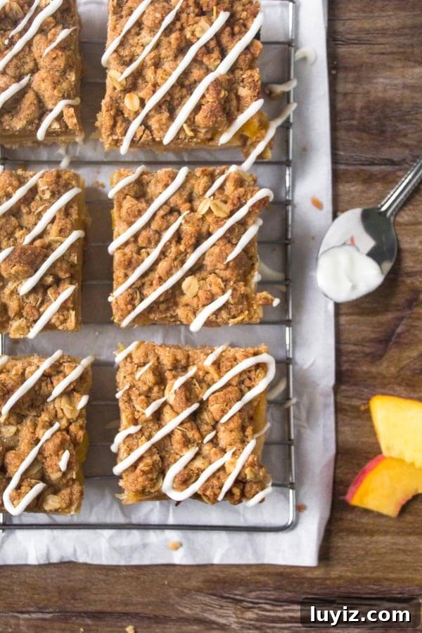 Peach Crumble Bars with Buttery Oat Streusel 4 Peach Crumble Bars are filled with juicy peaches & have a buttery crumble topping & sweet glaze.