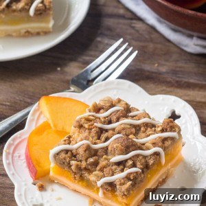 Peach Pie Crumble Bars have a buttery shortbread base, a layer of juicy peaches, & crunchy oatmeal crumble topping