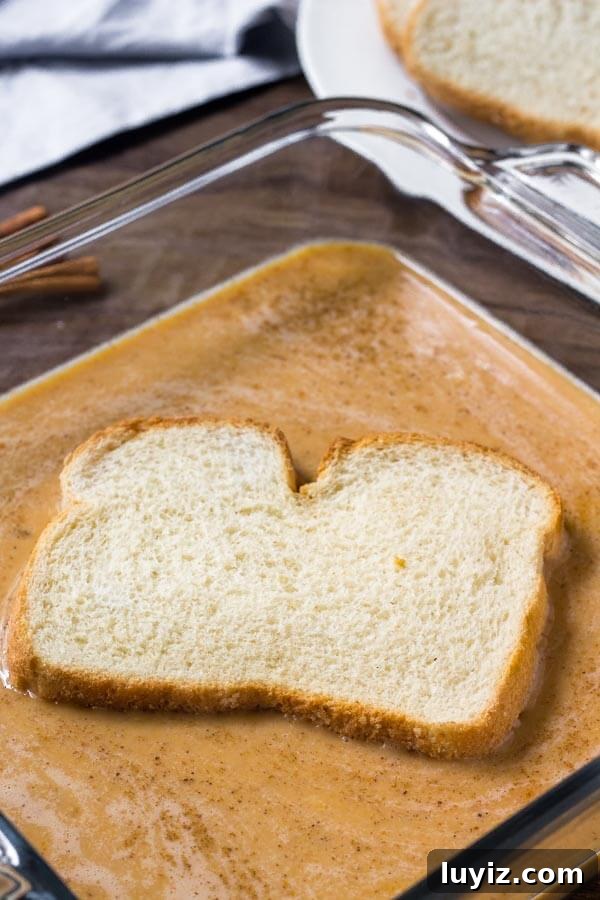 Creamy Pumpkin French Toast Recipe for Fall Brunch 4 Bread being dunked in pumpkin French toast batter to show how to make it.