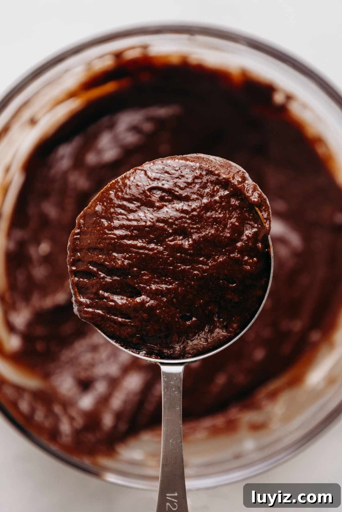 Cream Cheese Swirled Chocolate Chip Brownies 12 A portion of brownie batter reserved in a measuring cup.