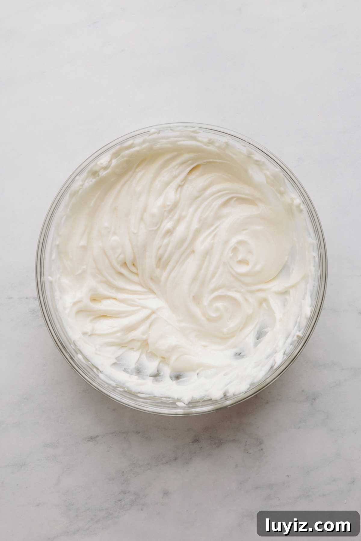 Cream Cheese Swirled Chocolate Chip Brownies 7 Cream cheese, sour cream, and sugar mixed together in a bowl.