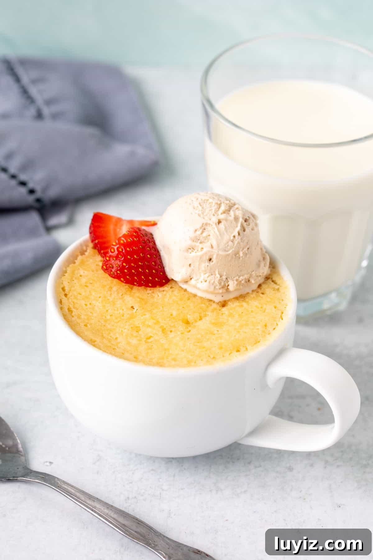 Quick Vanilla Mug Cake Recipe for One — Ready in Minutes 3 Moist vanilla mug cake topped with a scoop of ice cream and strawberies