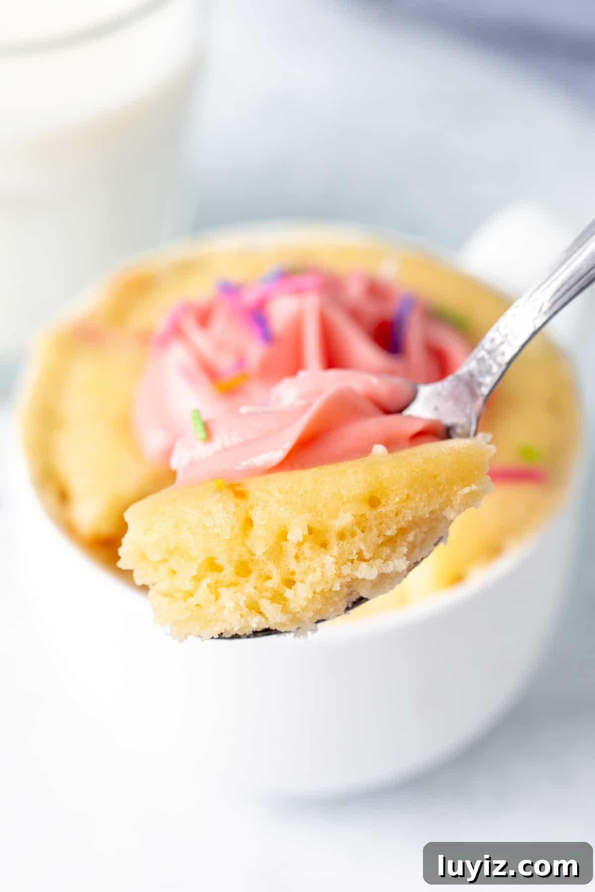 Quick Vanilla Mug Cake Recipe for One — Ready in Minutes 8 Spoon with a scoop of vanilla cake made in a mug