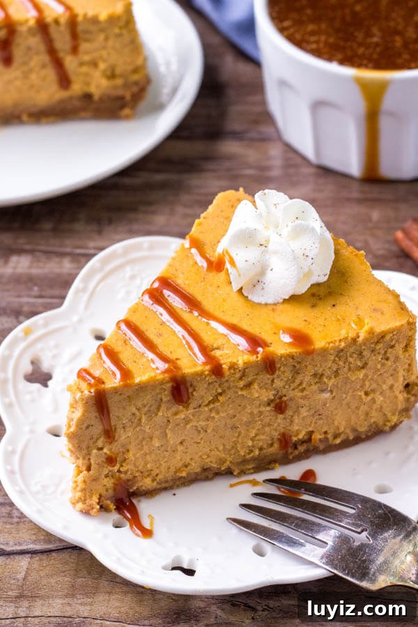 Creamy Pumpkin Cheesecake Recipe Perfect for Thanksgiving Dessert 2 Pumpkin Cheesecake with graham cracker crust and a drizzle of salted caramel sauce. Smooth, creamy & filled with pumpkin spice.
