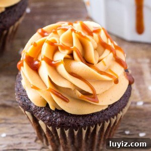 Chocolate cupcakes with caramel frosting are moist, tender and topped with caramel buttercream & a drizzle of salted caramel.