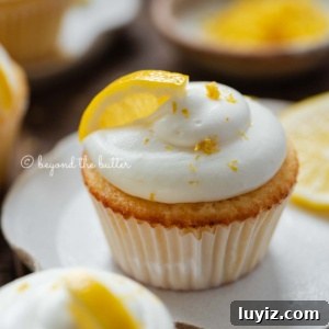 Mini Lemon Cupcakes: Perfect Small-Batch Recipe for 6-8 Servings 10 Lemon cupcakes with lemon cream cheese frosting garnished with lemons on small wavy dessert plates.