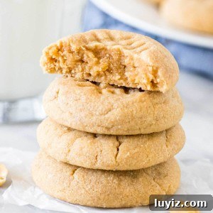 3-Ingredient Peanut Butter Cookies Recipe — Quick Homemade Treat 6 Stack of 4, three ingredient peanut butter cookies with the top cookie broken in half.