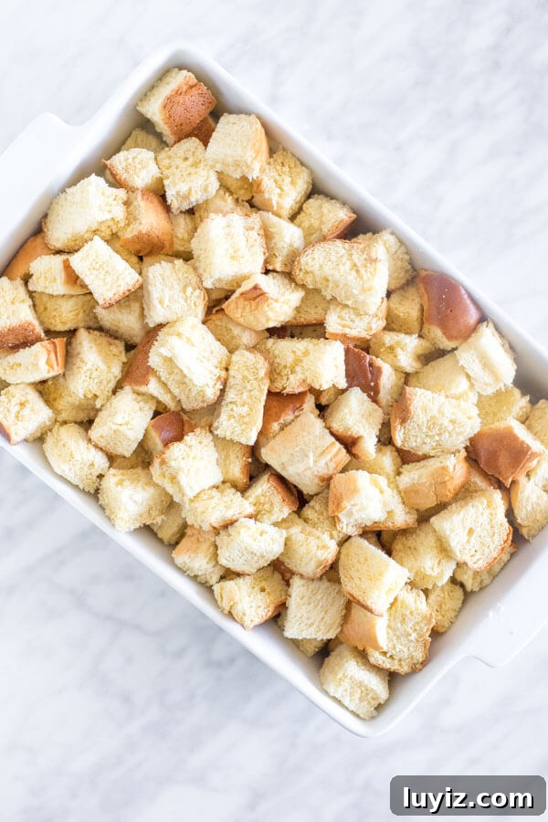 Make-Ahead French Toast Casserole for Brunch or Holiday Mornings 3 Casserole dish of bread cut into pieces to make French toast bake.