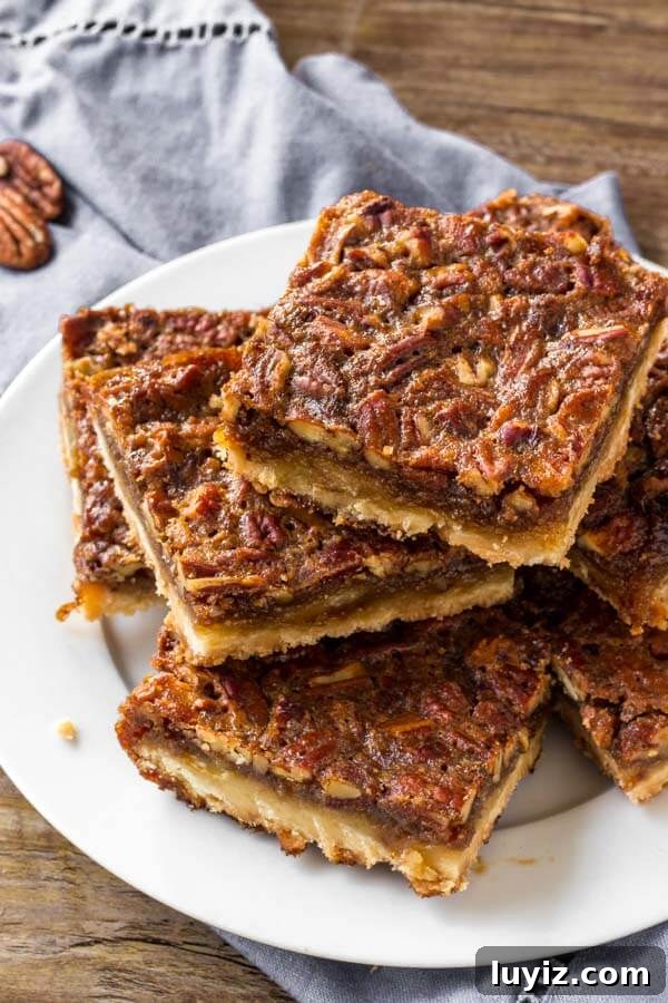 Decadent Pecan Pie Bars Recipe for Parties and Gifting 4 A plate of pecan pie bars.