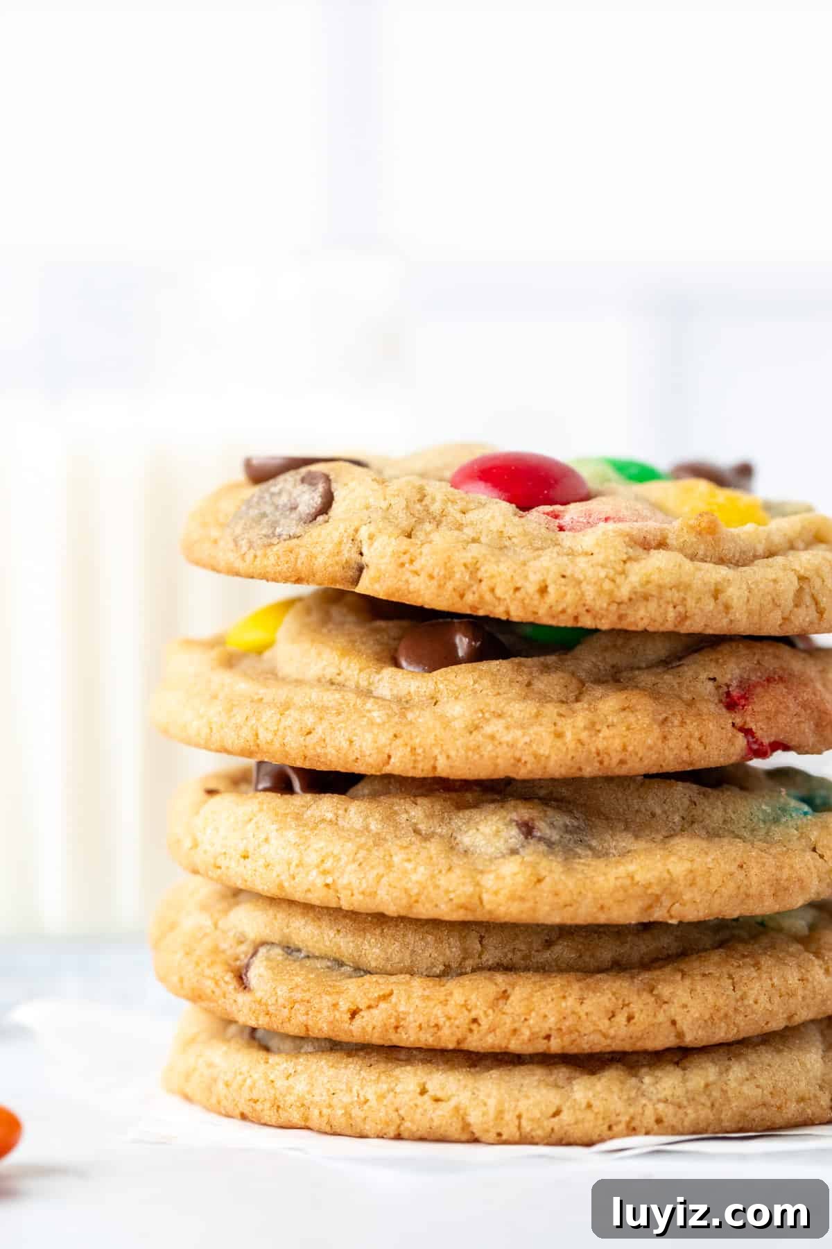 Soft & Chewy M&M Cookies That Melt in Your Mouth 3 Stack of 5 M&M chocolate chip cookies with glass of milk