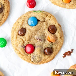 Soft & Chewy M&M Cookies That Melt in Your Mouth 9 M&M chocolate chip cookies on baking paper