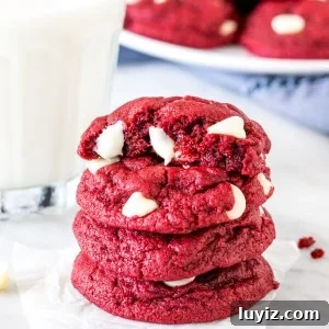 Red Velvet Cake Mix Cookies Recipe — Soft, Chewy Treats 6 Stack of 4 red velvet cake mix cookies with a glass of milk.
