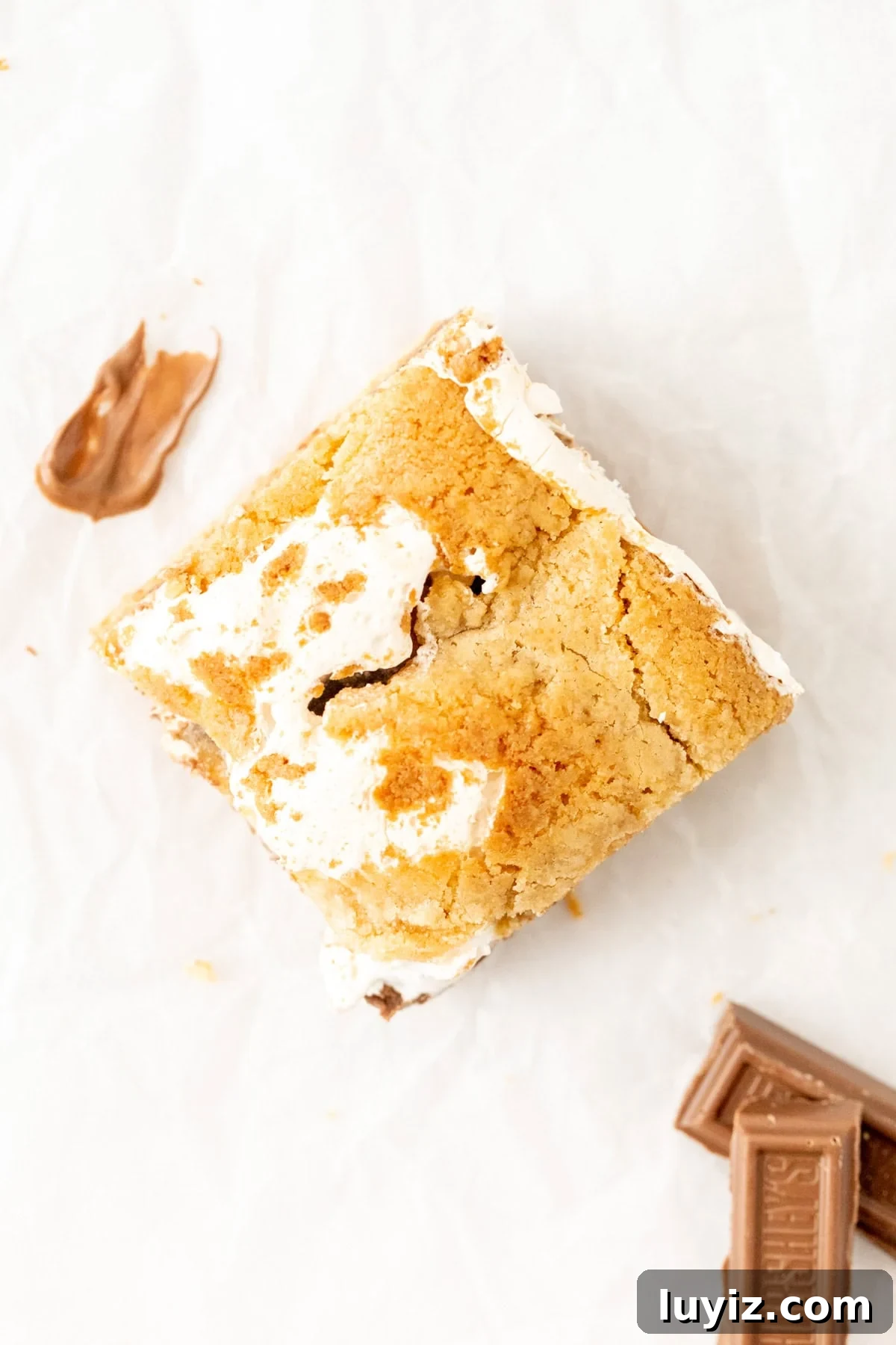 S'mores blondie cut into a square, with marshmallow fluff
