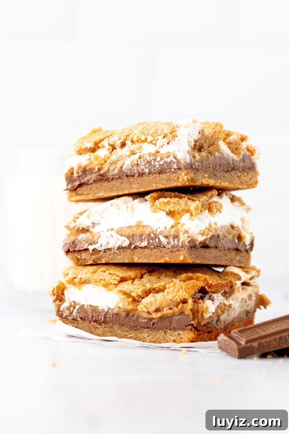 Stack of three layered peanut butter cookie s'mores bars