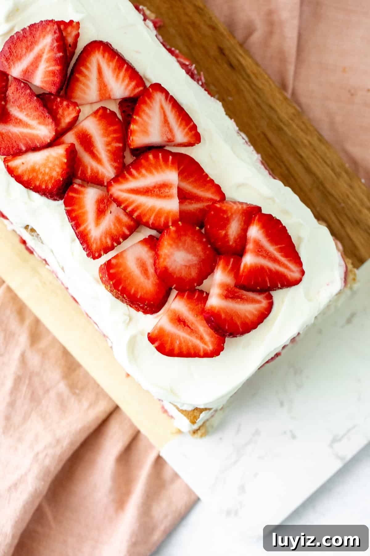 Strawberries and cream icebox cake topped with sliced berries