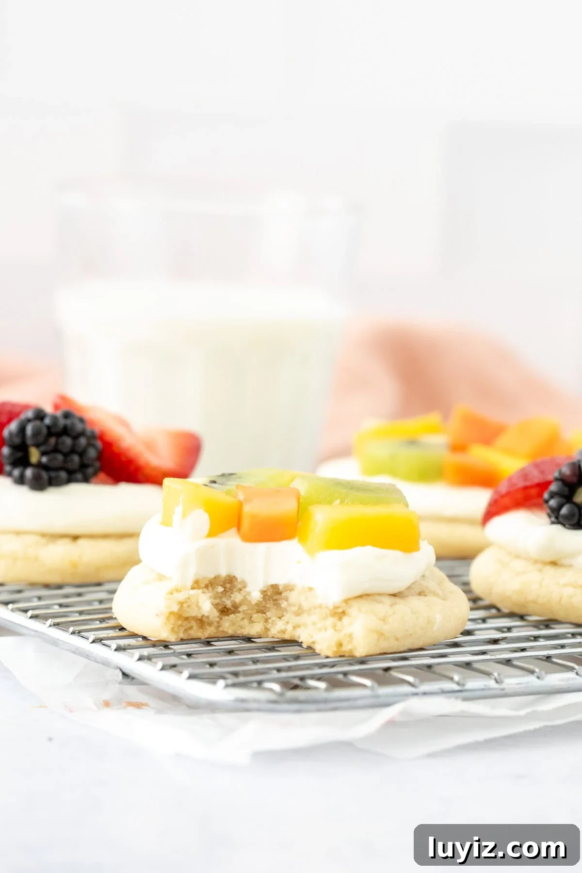 Mini Fruit Pizza Bites: Party Dessert Recipe 6 Individual fruit pizza with a bite taken out