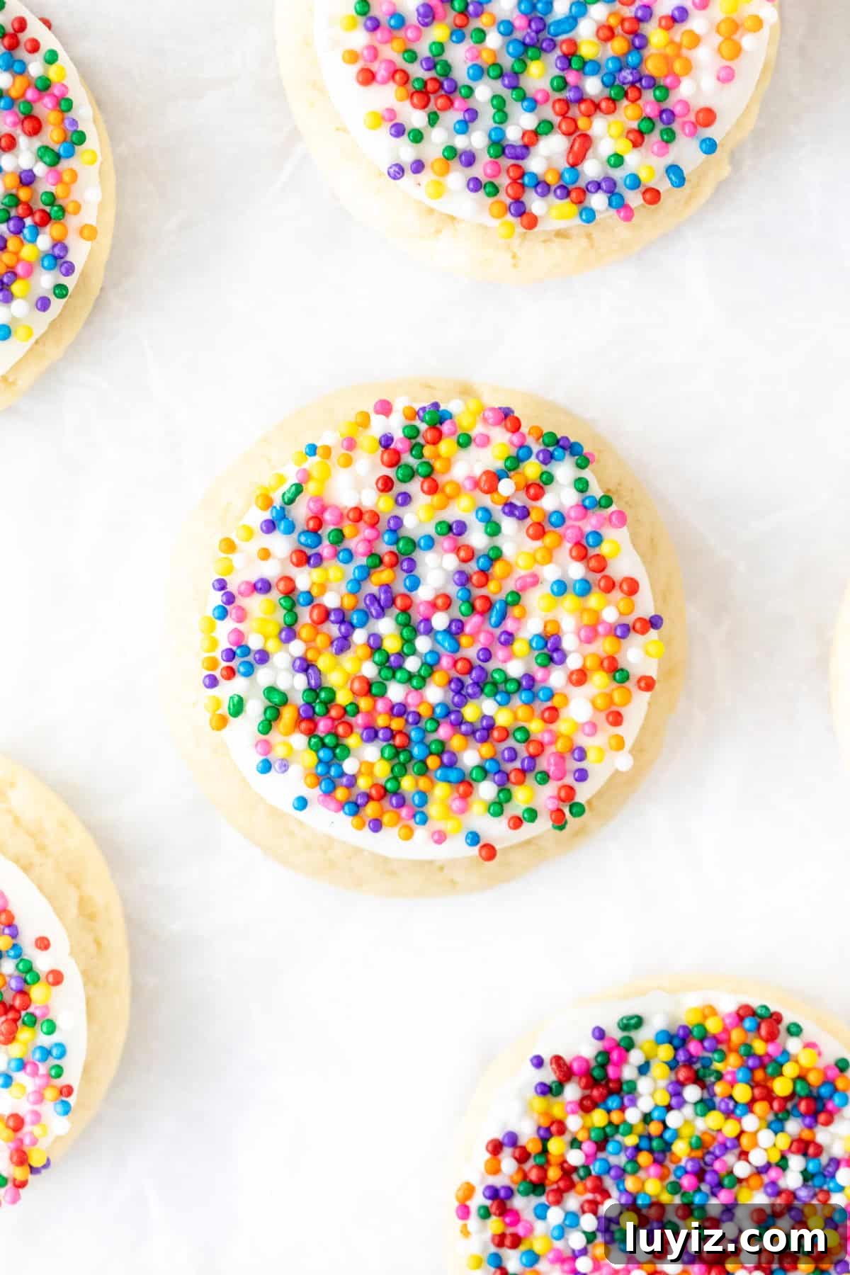 Sugar cookies with vanilla frosting and nonpareil sprinkles