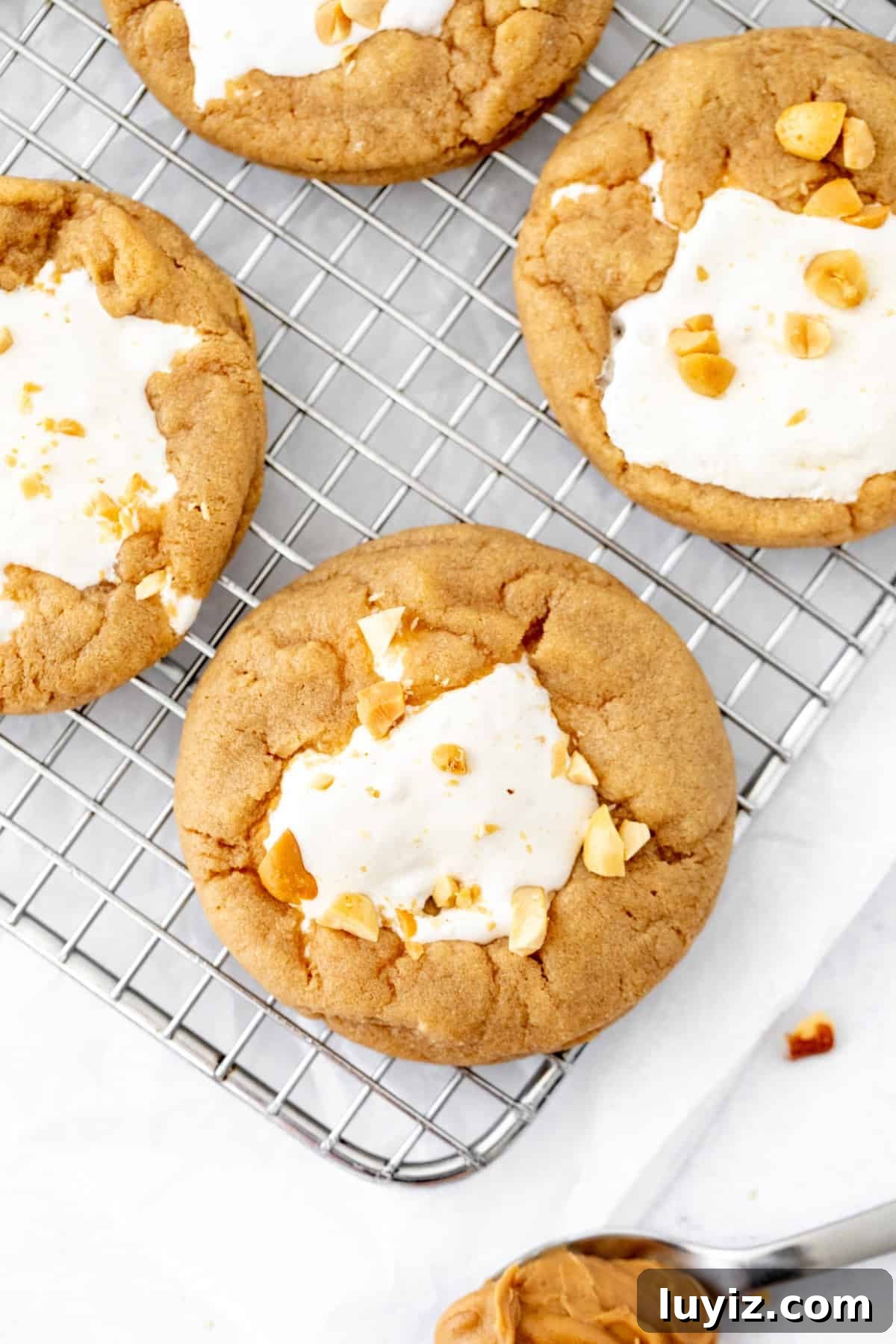 fluffernutter cookies with marshmallow fluff in the middle on a cooling rack