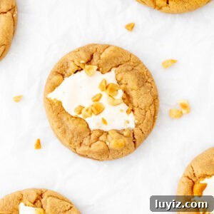 Fluffernutter cookies with marshmallow fluff in the middle and chopped peanuts on top