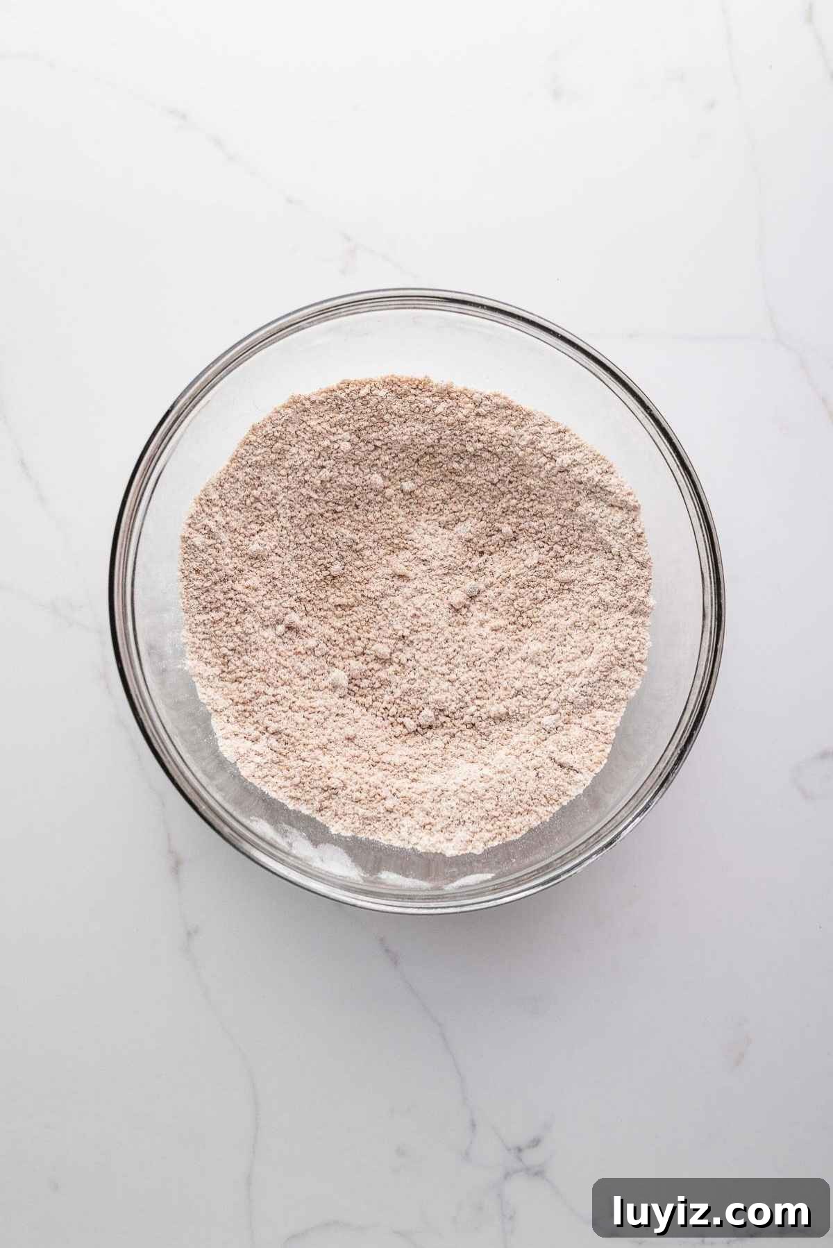 Whisked flour, brown sugar, and cinnamon in a bowl.