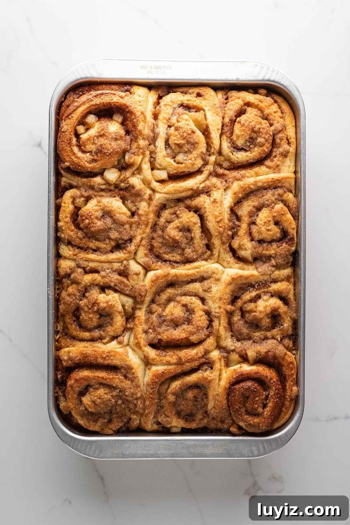 Baked apple cinnamon rolls topped with streusel.